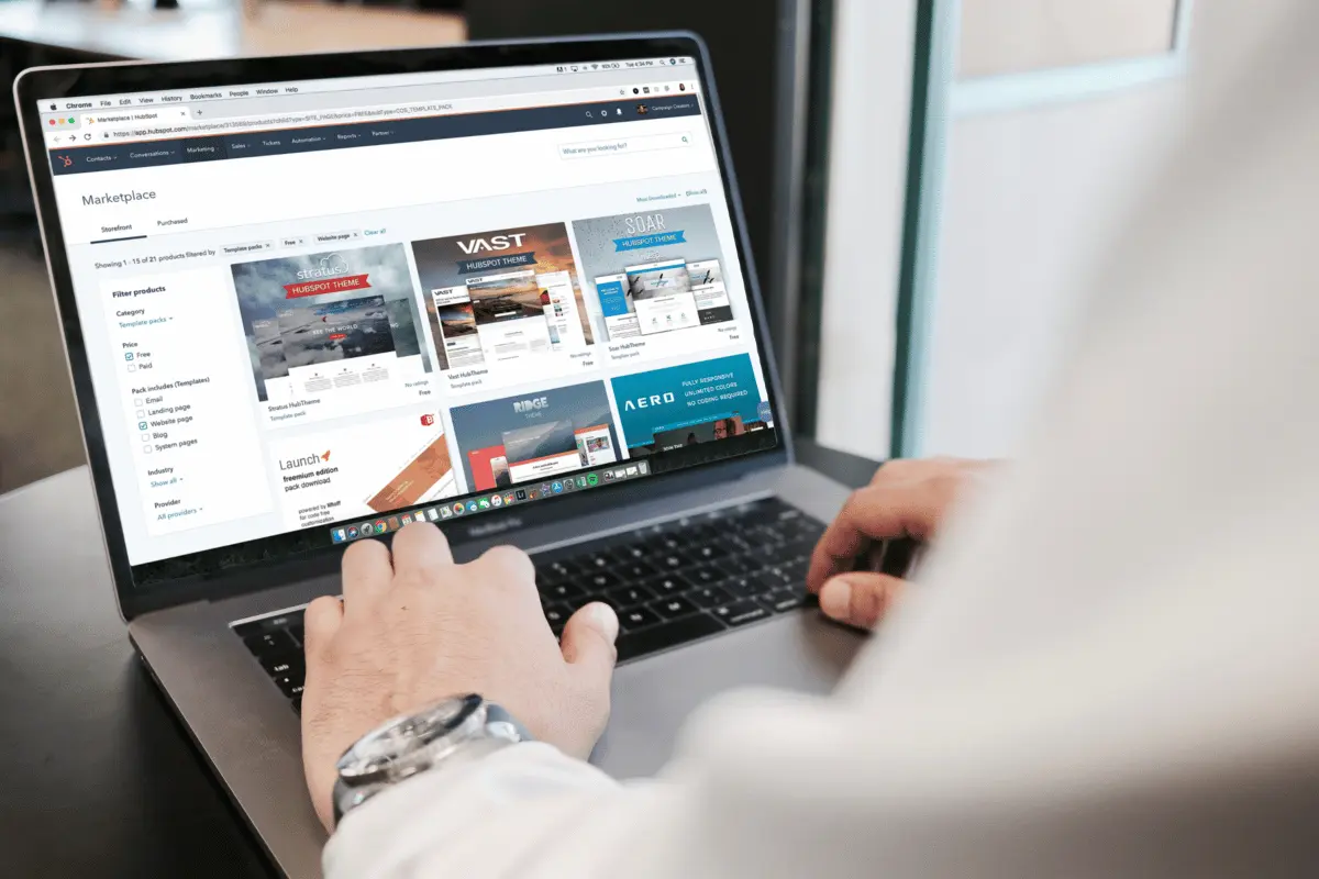 Close-up of hands typing on a laptop showcasing an online marketplace platform.