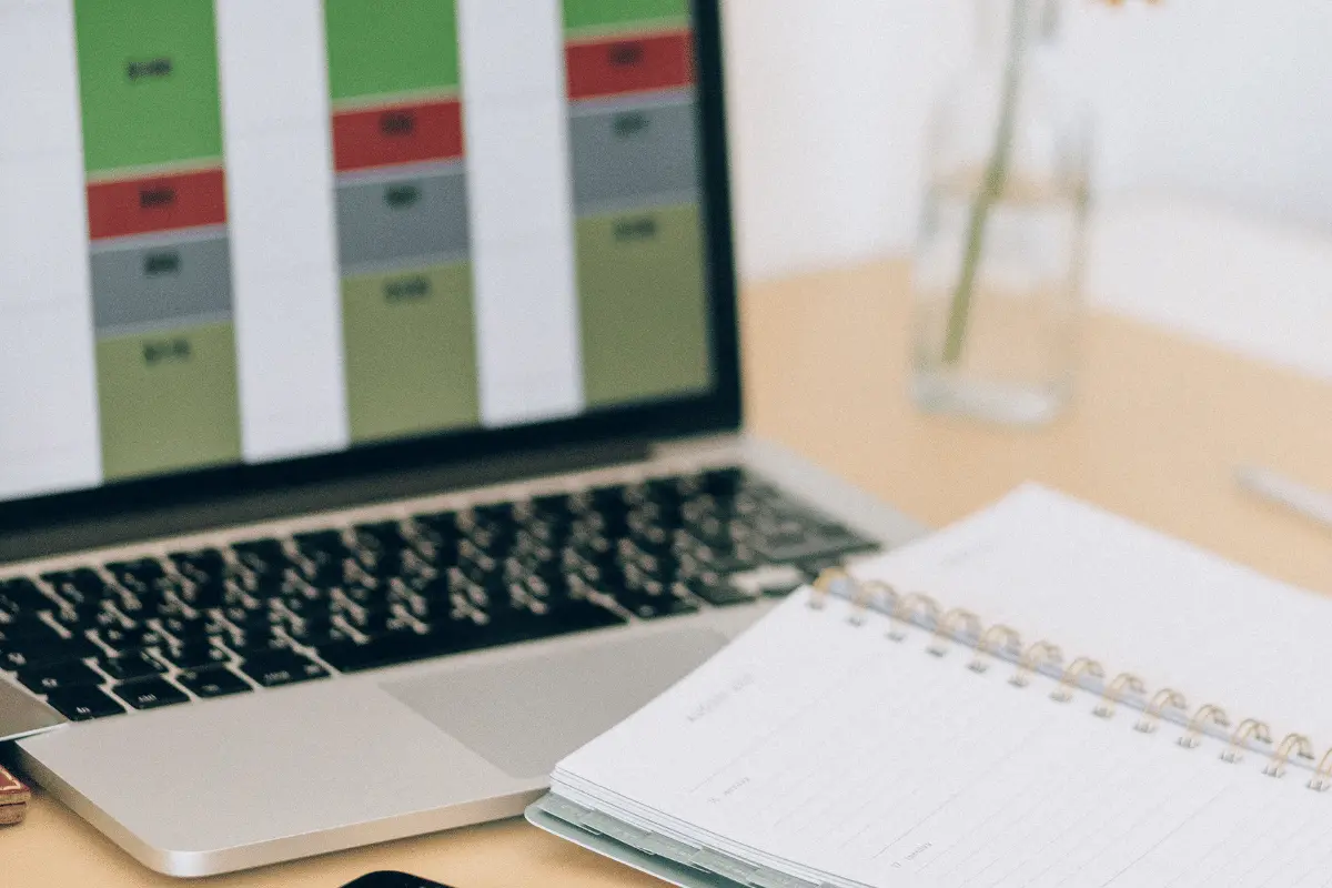 Professional planning setup with a laptop showing a timeline and a clean notebook.