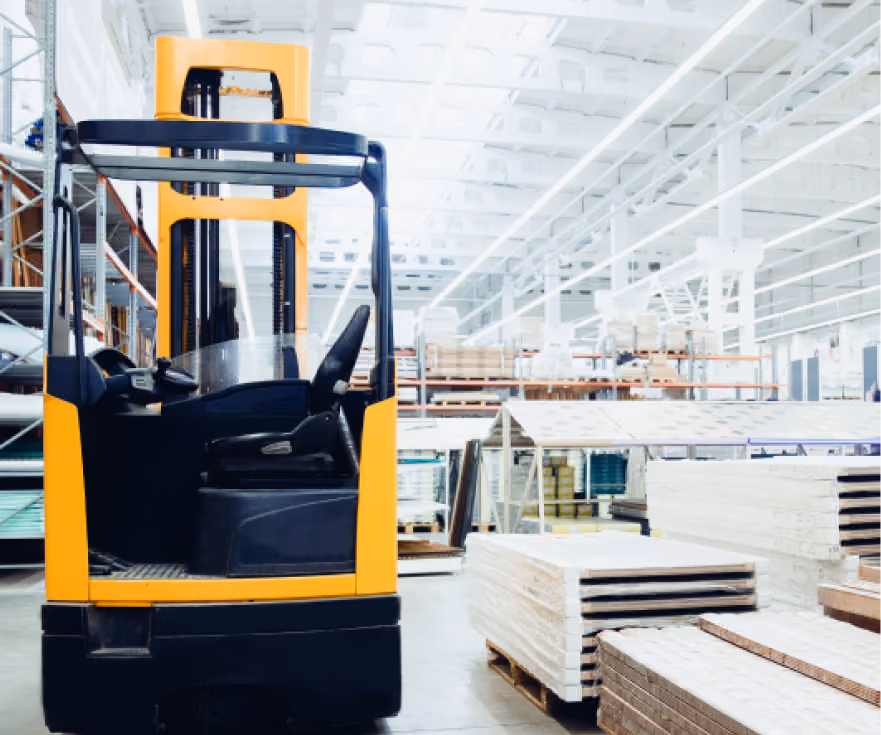 Electric forklift in a modern warehouse setting, surrounded by stacked materials