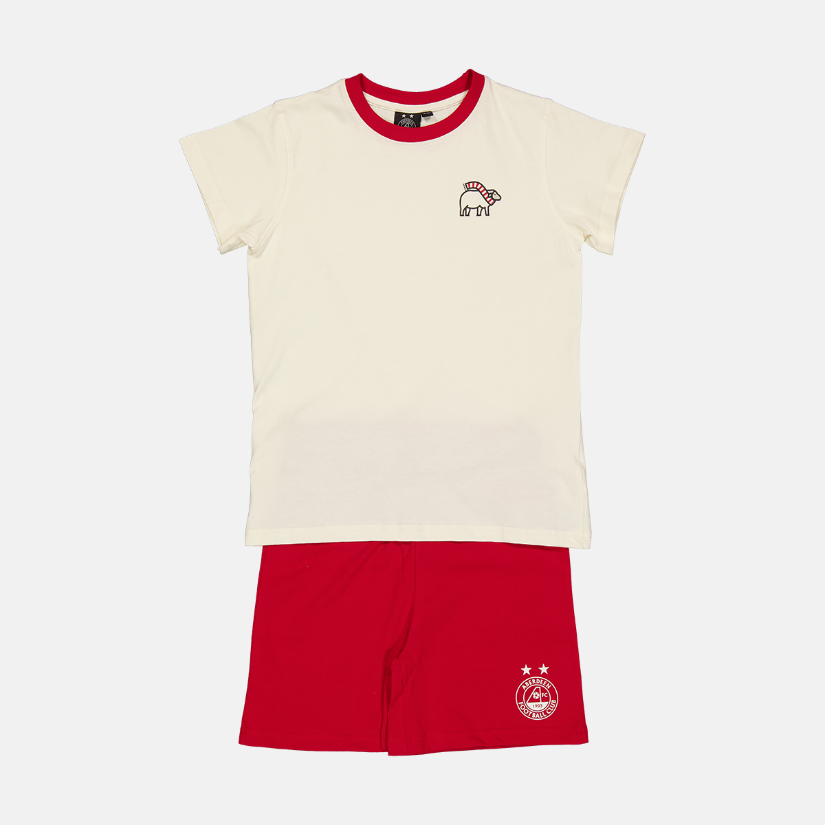 Two-piece kids' outfit with a cream short-sleeve top featuring a red collar and sheep graphic, paired with red shorts displaying a white Aberdeen Football Club logo.