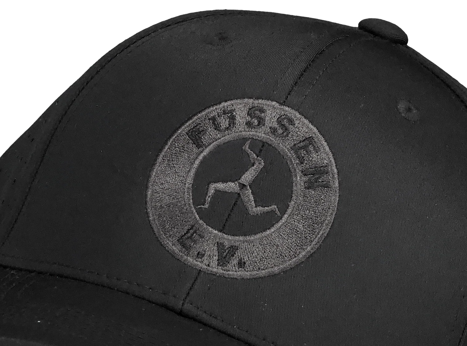 Black cap with a circular embroidered logo showing a figure with bent limbs and the text 'FUSSEN E.V.' around it.