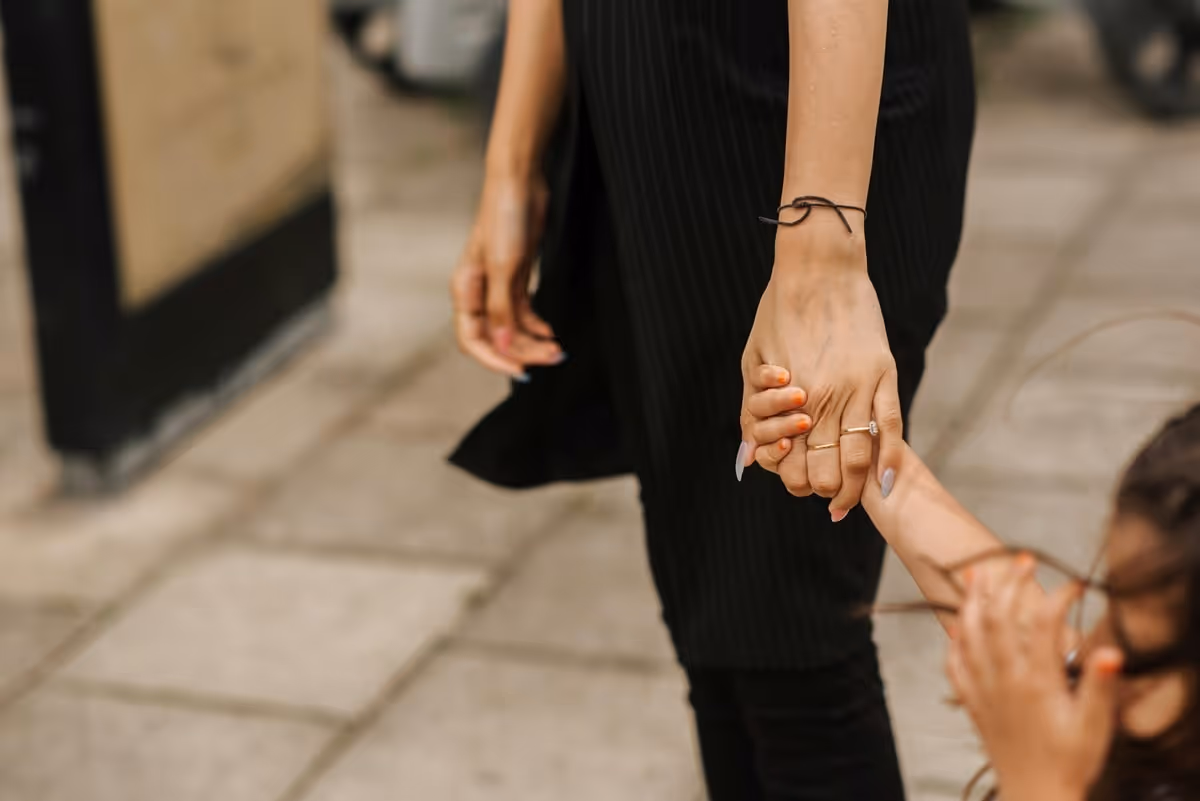 Mother Holding her daughter's hand walking