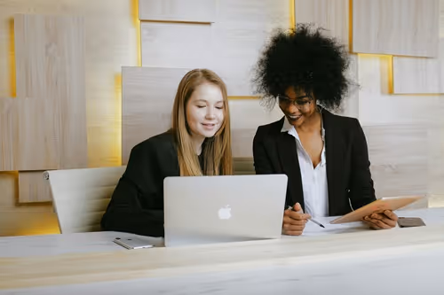 HR onboarding with two people sitting at a laptop