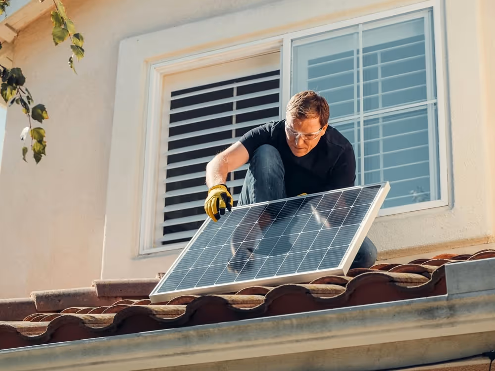 Man working on a roof with Solar Panel