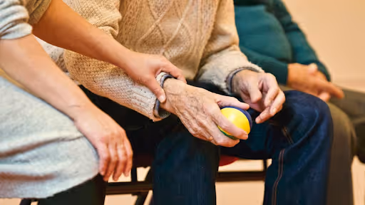 Woman holding the wrist of an elderly man