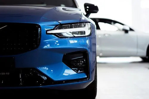 The front of a blue car in a showroom.