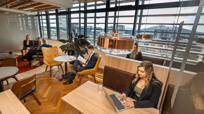 A small team is collaborating in a breakout space within an office space in Canberra.