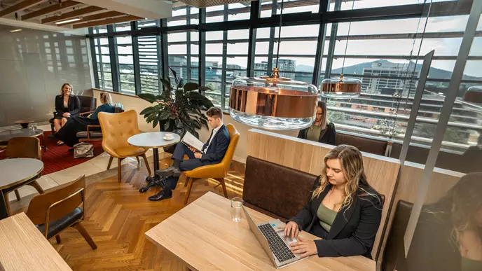 A small team is collaborating in a breakout space within an office space in Canberra.