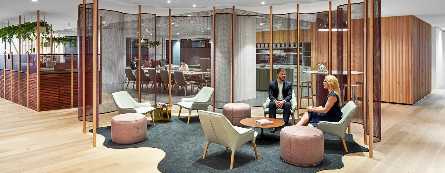 A small team is collaborating in a breakout space within The Executive Centre Collins Square. 