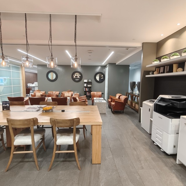A brightly lit, spacious breakout space in an office space in Singapore.