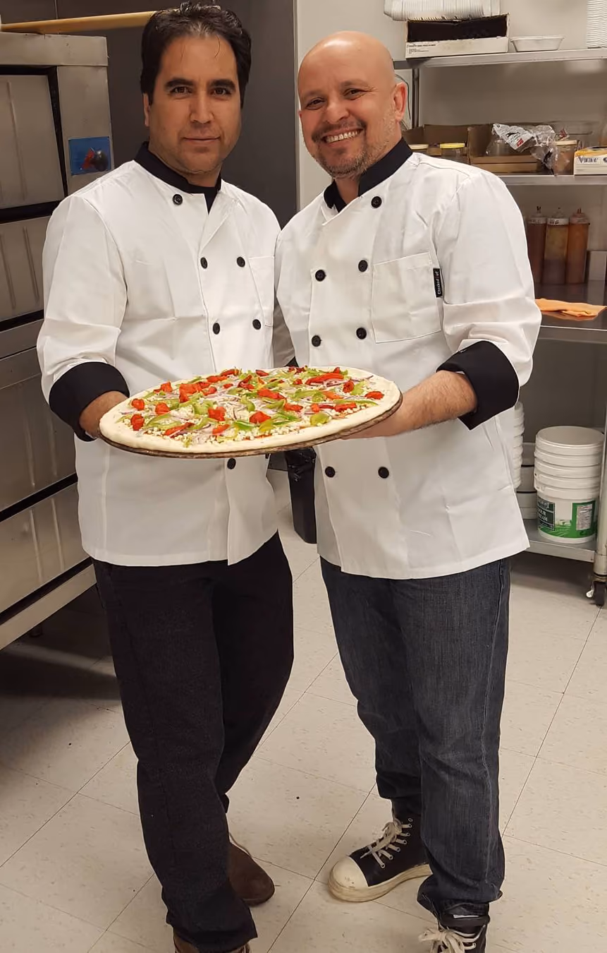 Joe holding a pizza