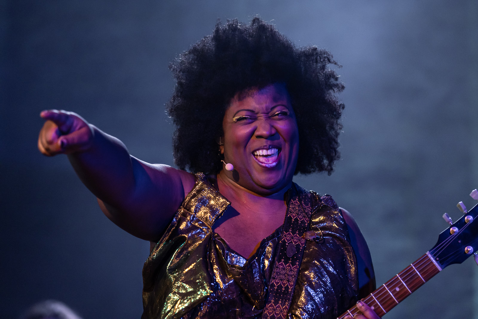 Close up of Sky Deep singing and pointing during a live musical performance.