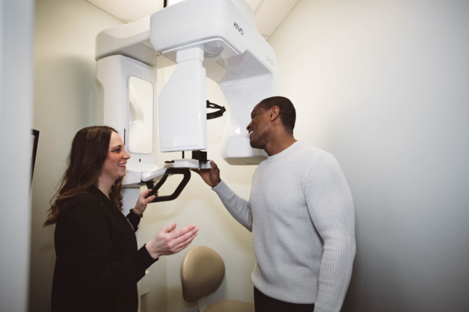 Dentist performing digital imaging scan on patient's teeth