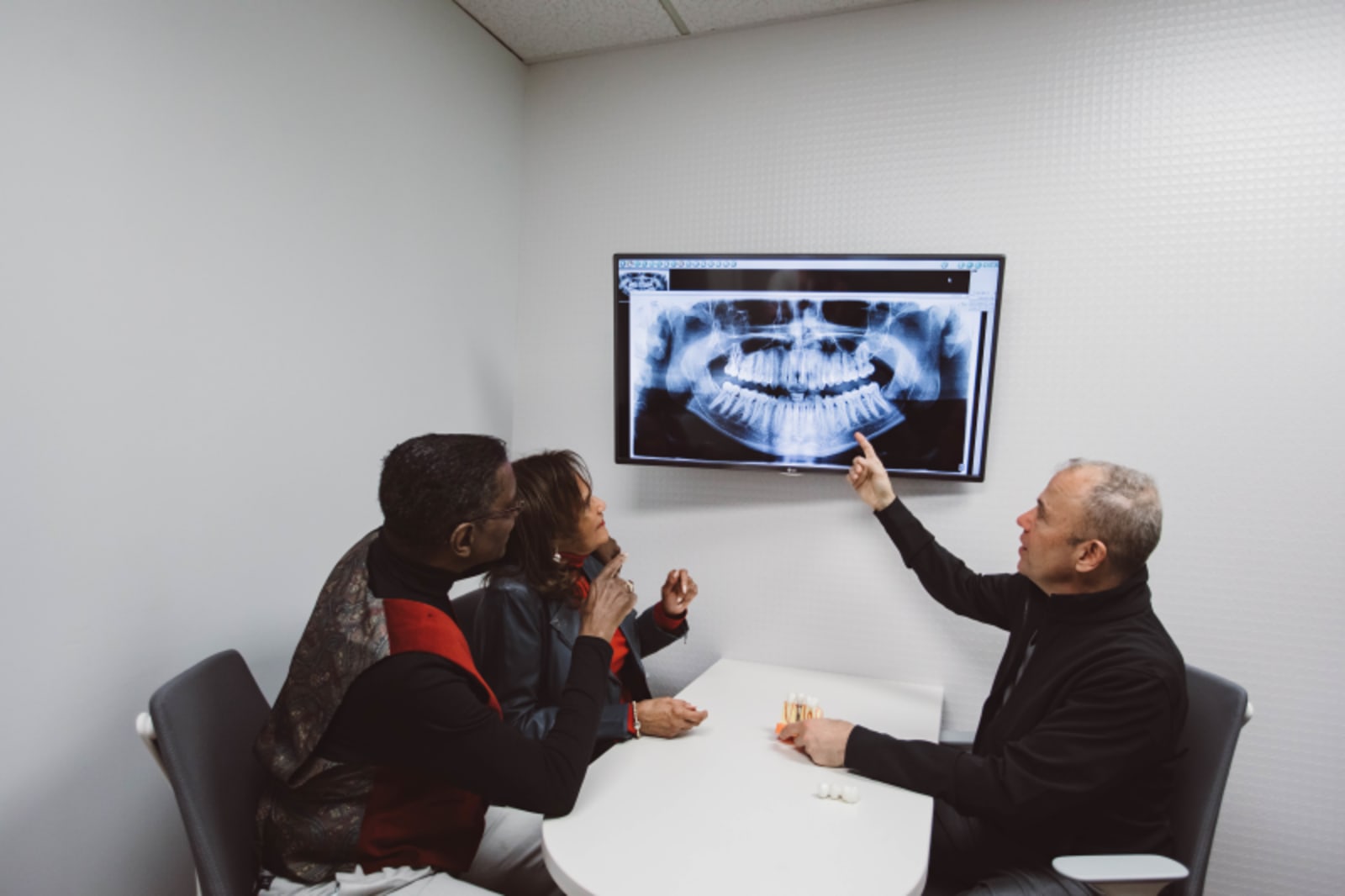 Dentist and patient reviewing dental imaging on monitor together