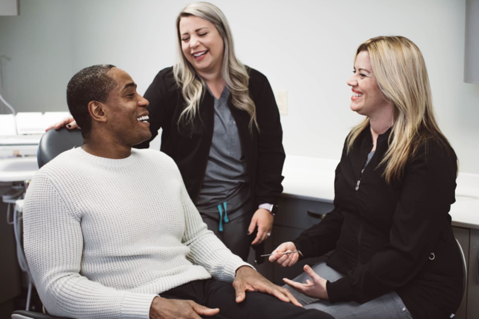 Dentist examining patient's teeth during clinical assessment