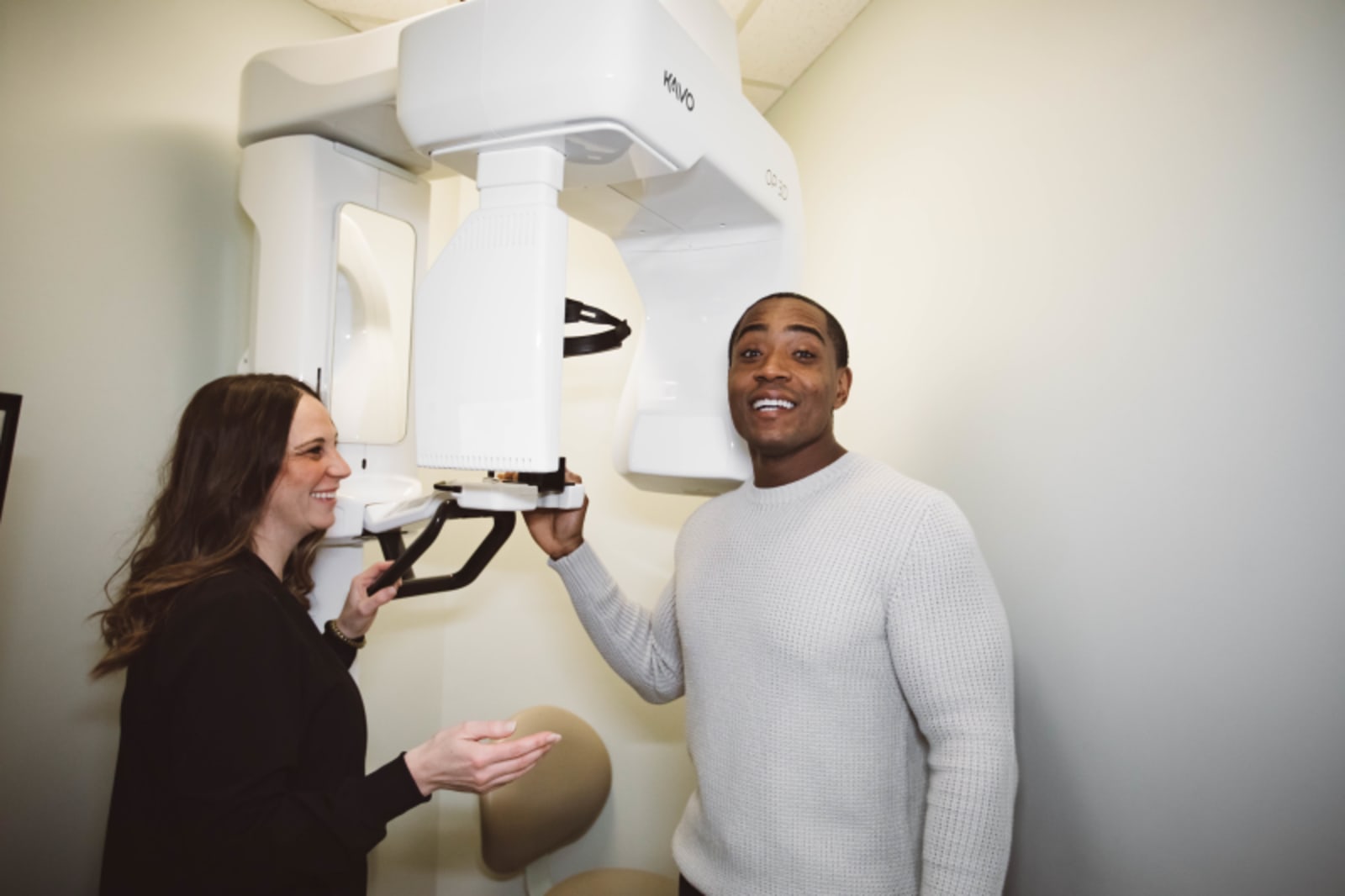 Dentist discussing preventive care with patient in treatment room