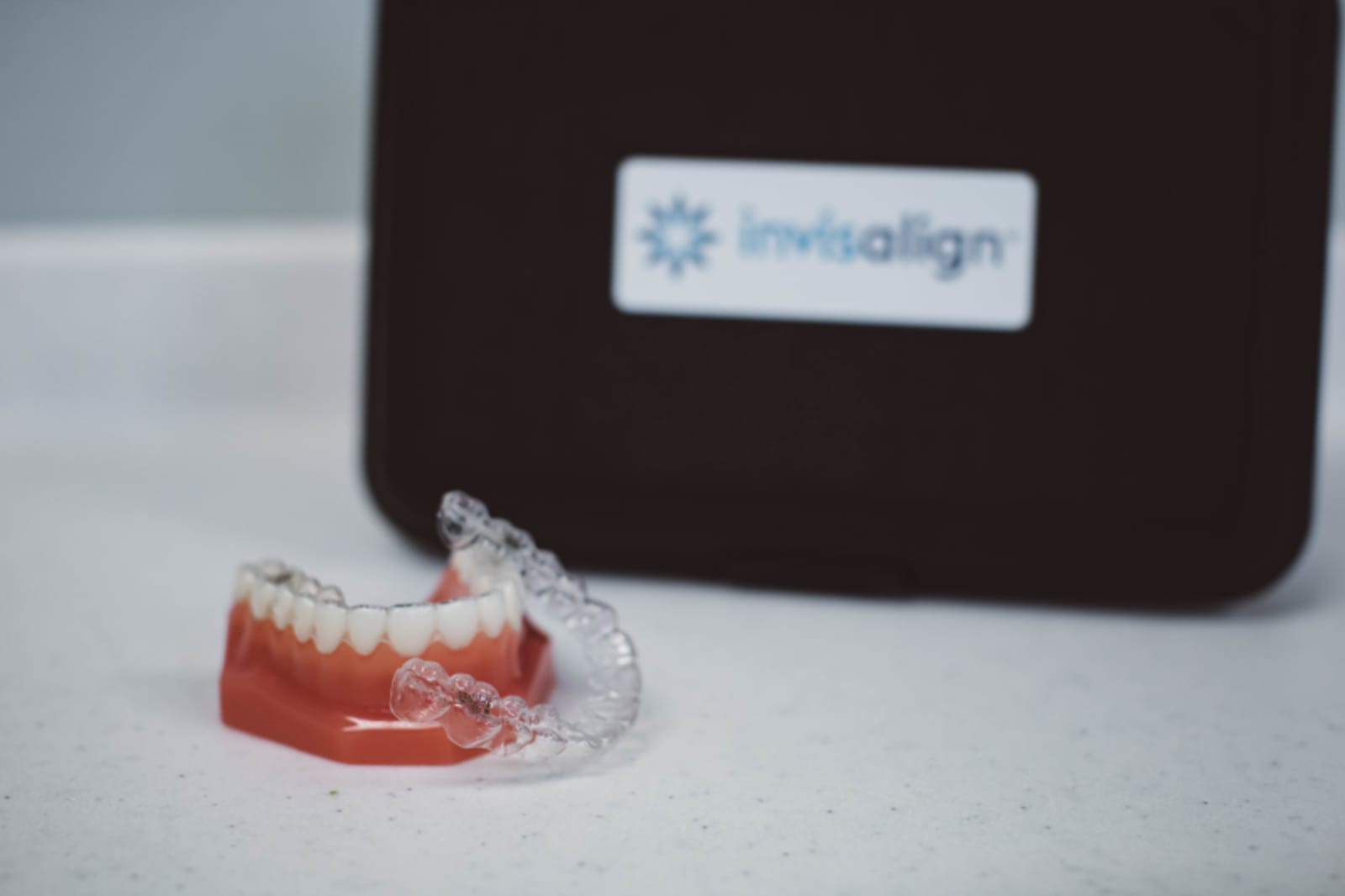 Close-up of dental model and Invisalign aligners showing treatment planning materials