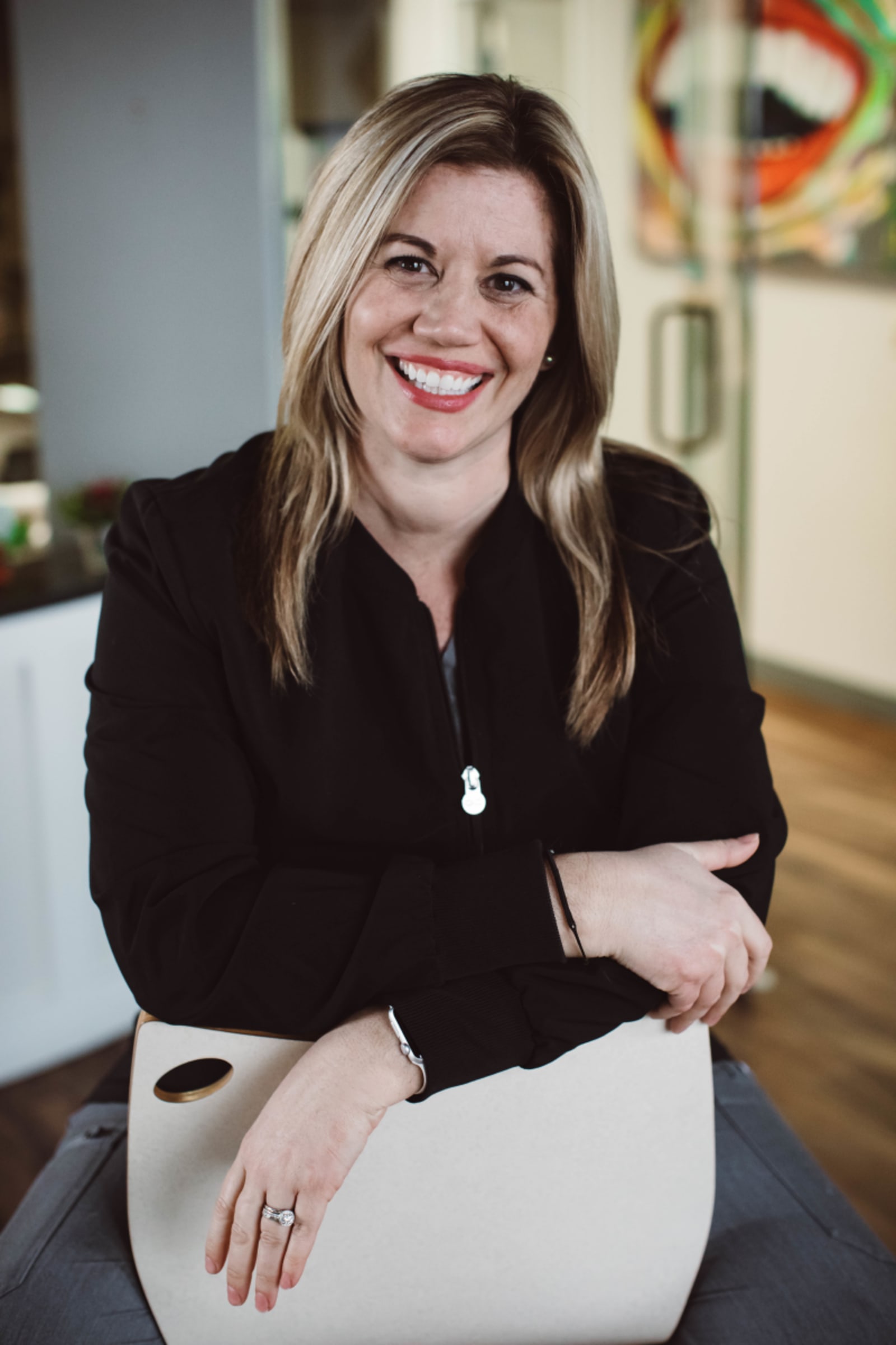 Female dentist smiling confidently in professional attire at the practice
