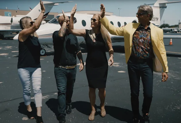 Lifestyle video thumbnail — day-in-the-life still of a real estate team