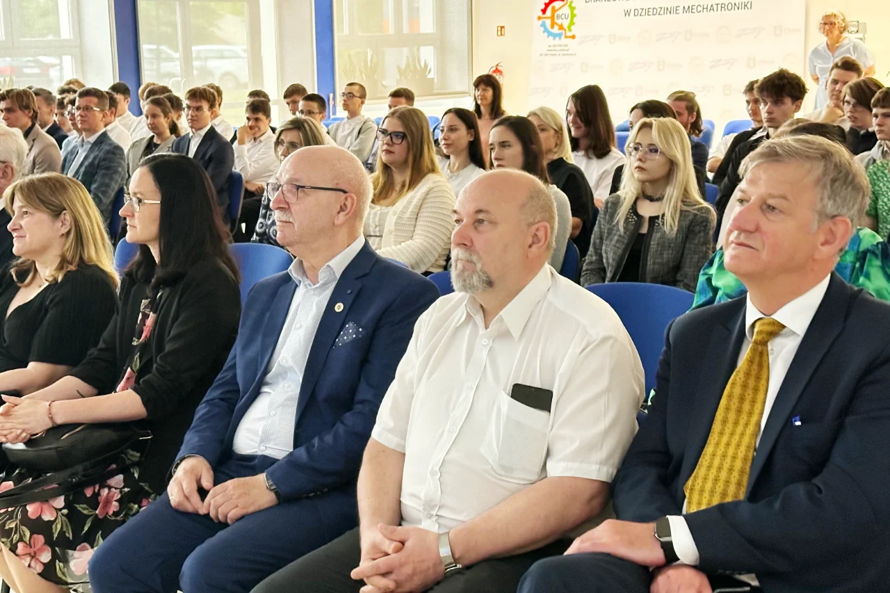 Guests and award sponsors in the front row at the Technical Innovation Olympiads ceremony in Chełm, students seated behind
