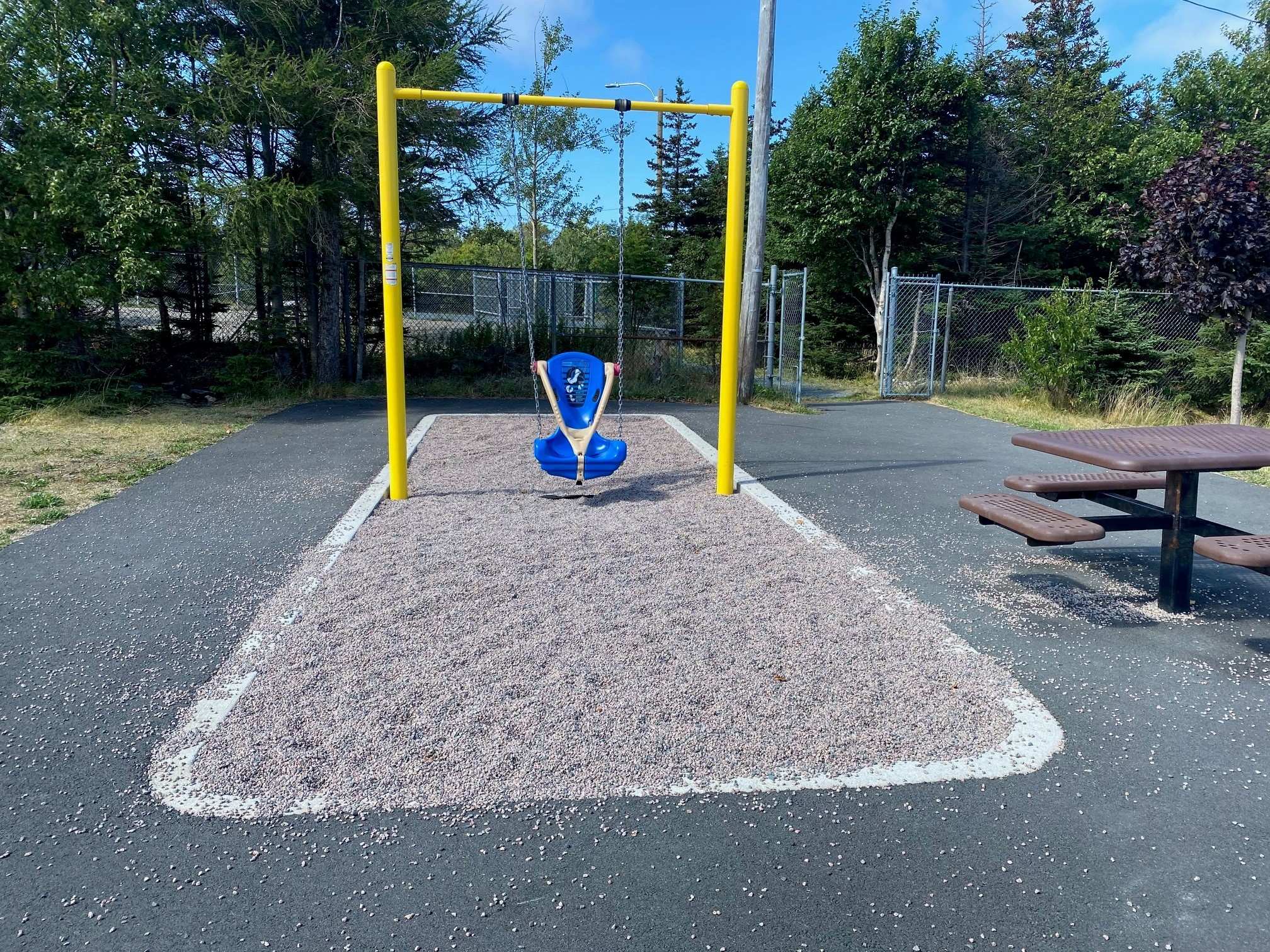 A wheel chair swing in a park