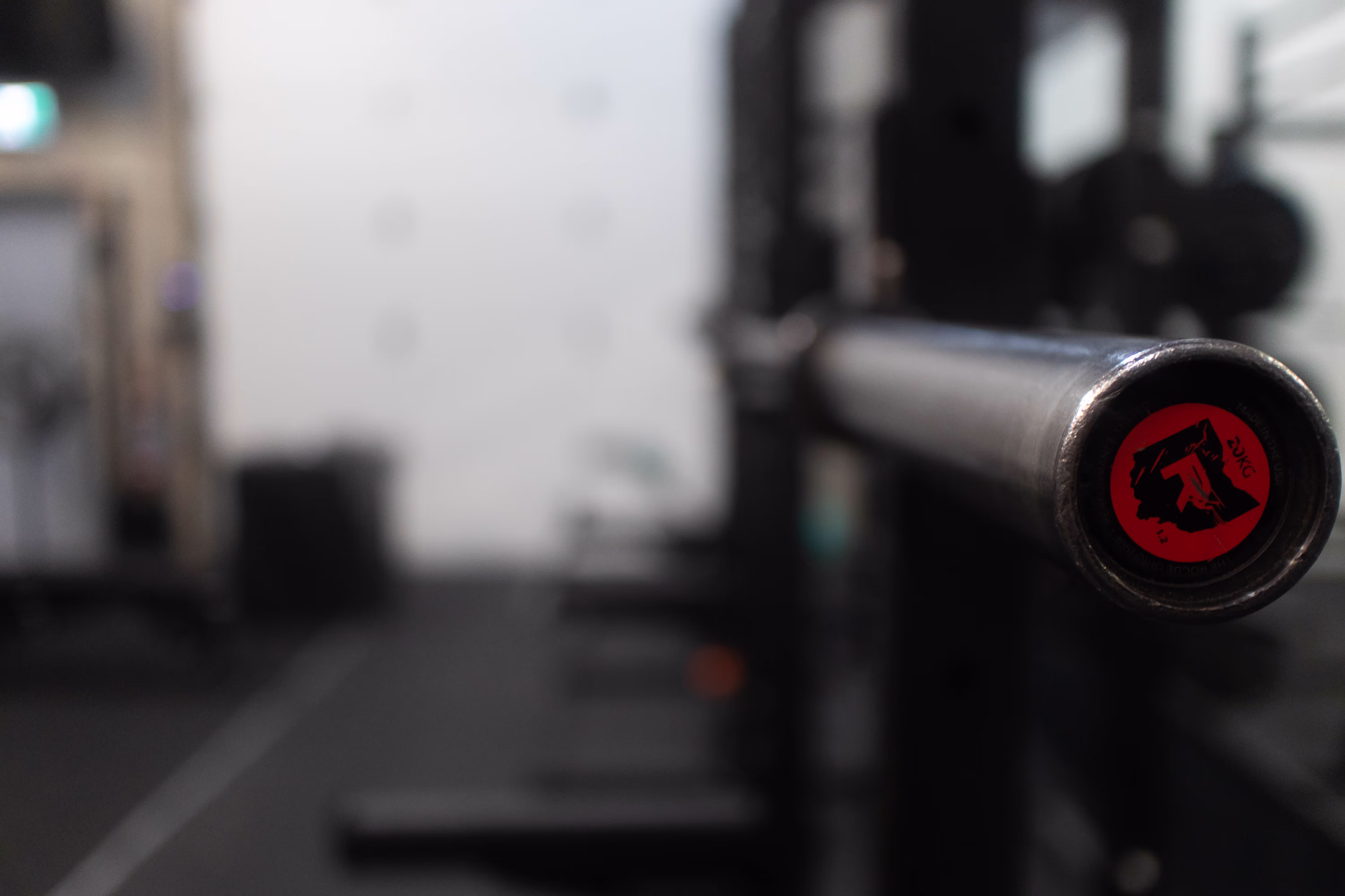 Picture of a Rogue Barbell on a Rogue squat rack.