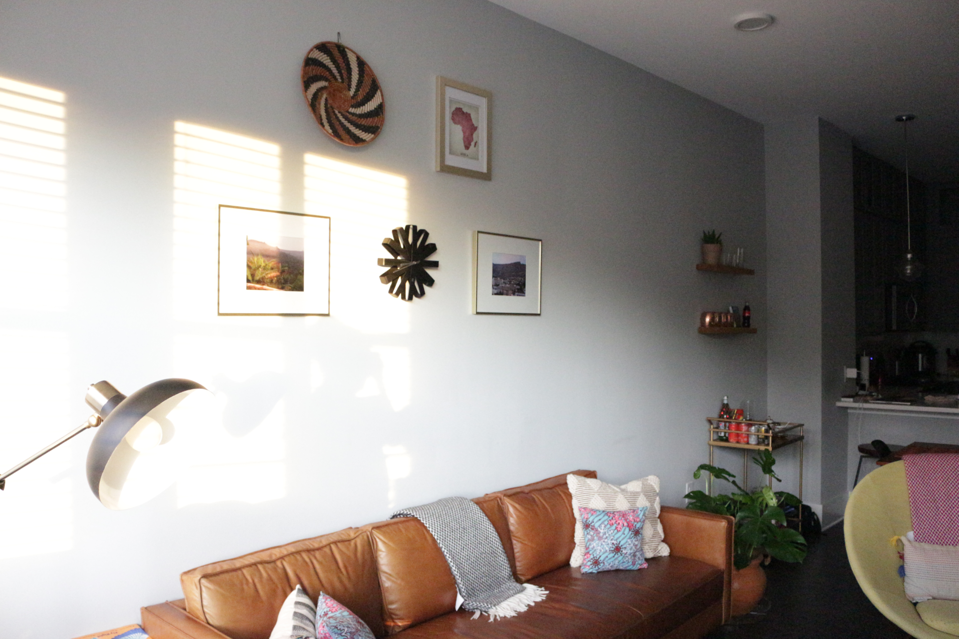 a picture of a couch with a frame design above it