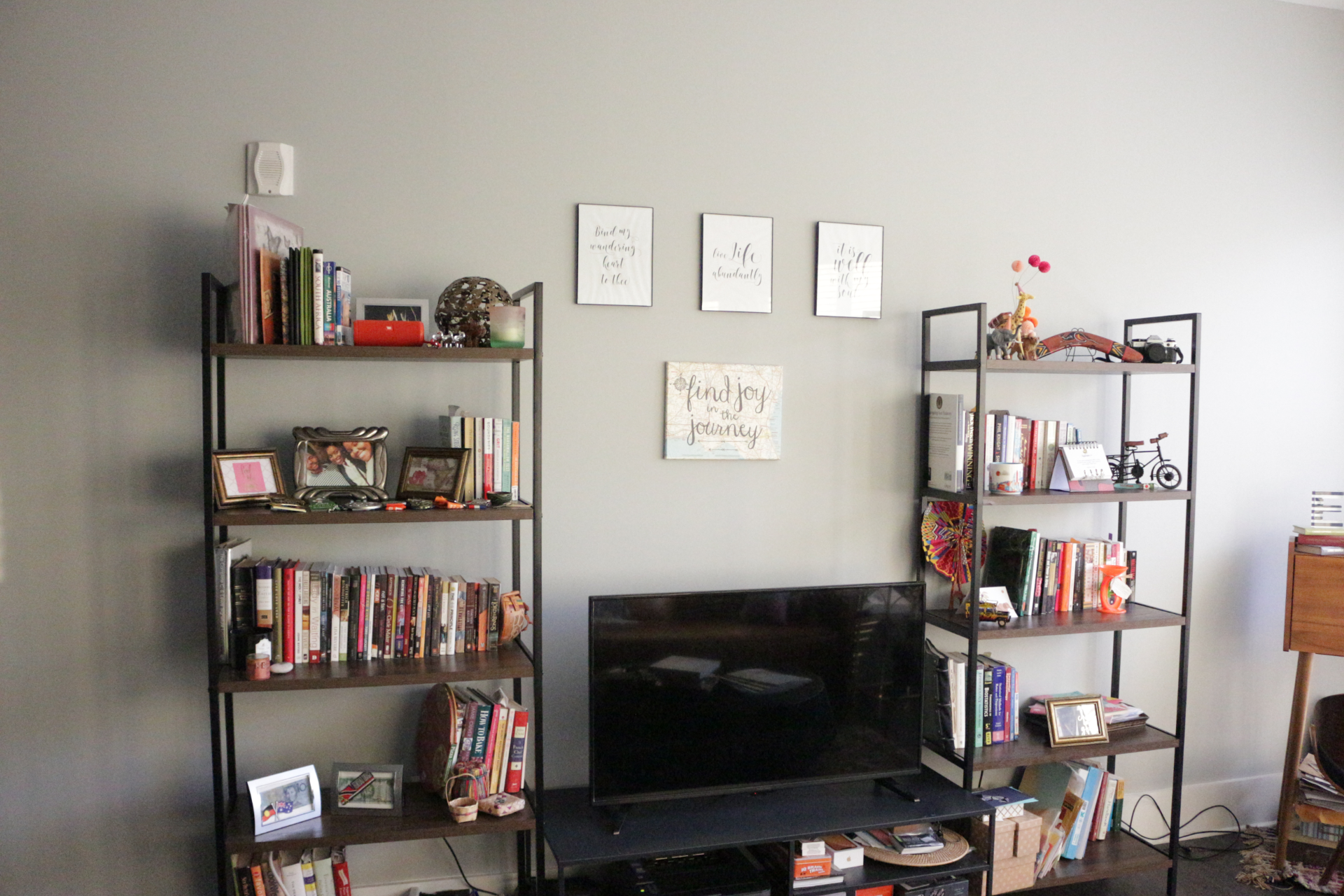 a picture of a tv unit next to two bookcases