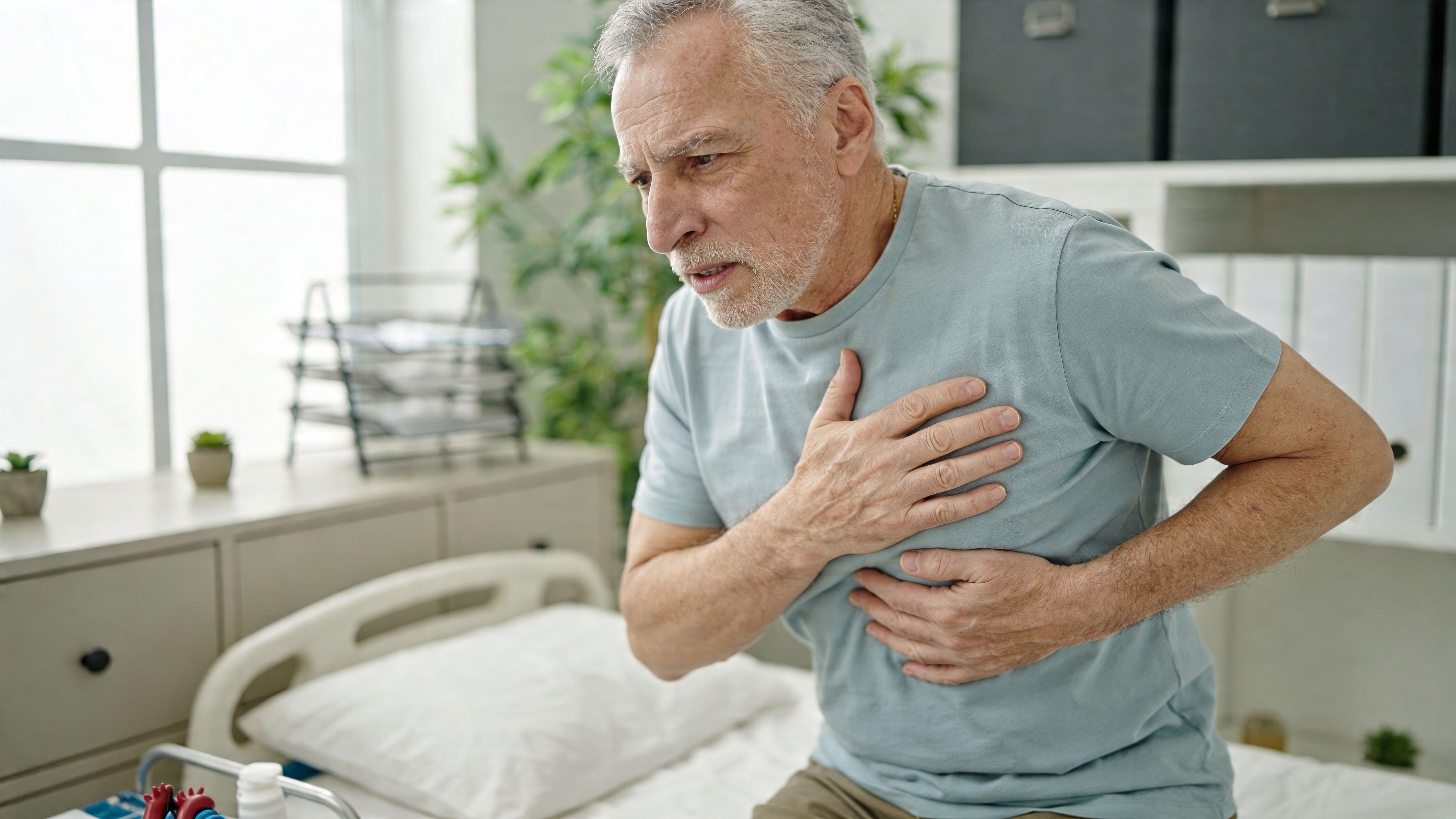 An elderly man experiencing chest pain and discomfort while sitting on a medical examination bed.