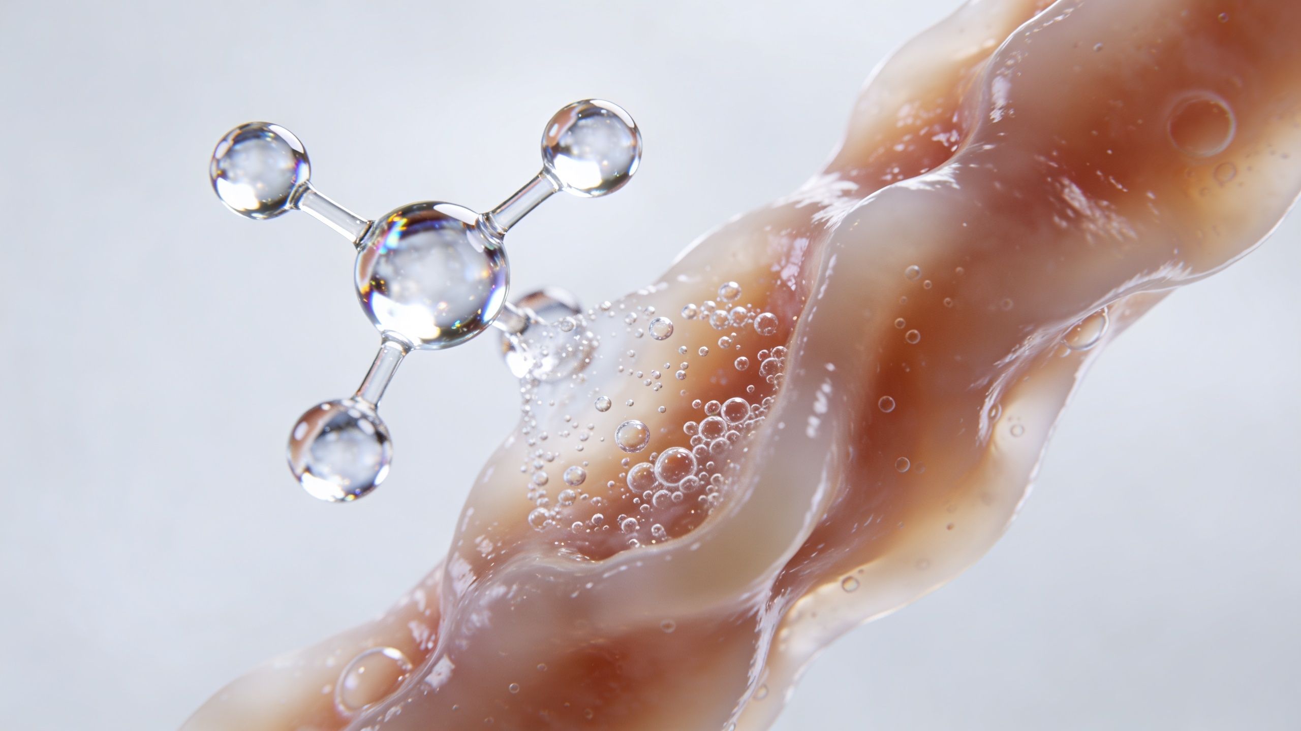A transparent molecular structure floating near a viscous beige fluid with small bubbles on a white background.