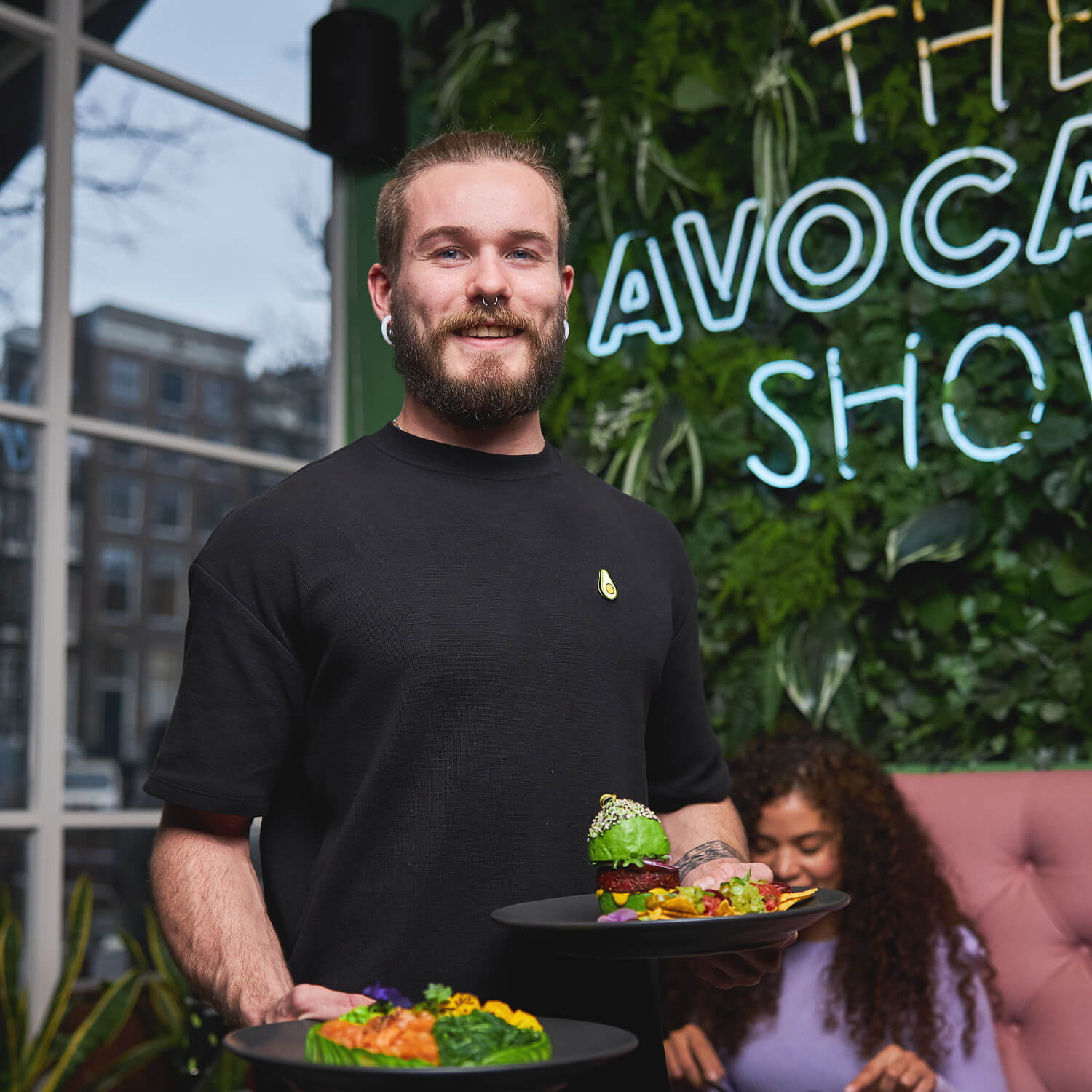 A member of our restaurant team serving avocado dishes