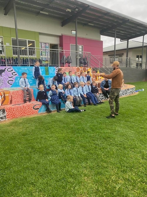 Hunter Barnes teaching a group of kids