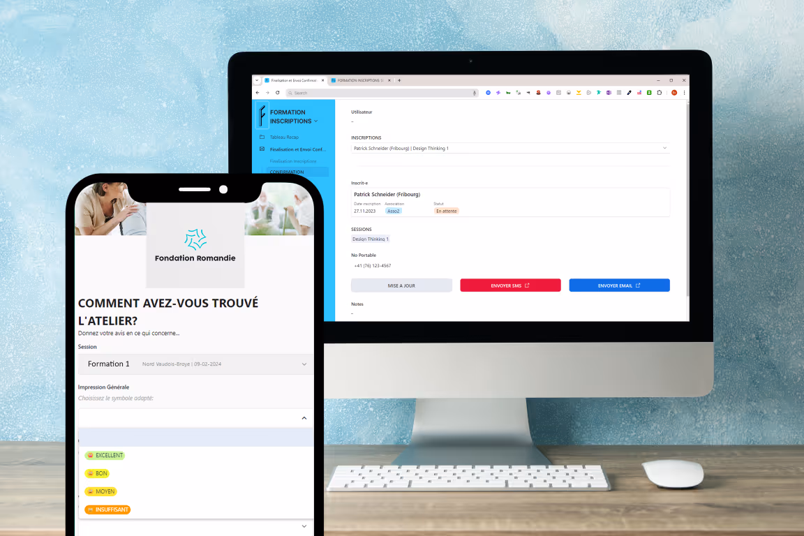 A computer monitor with a keyboard and a cell phone on a desk.