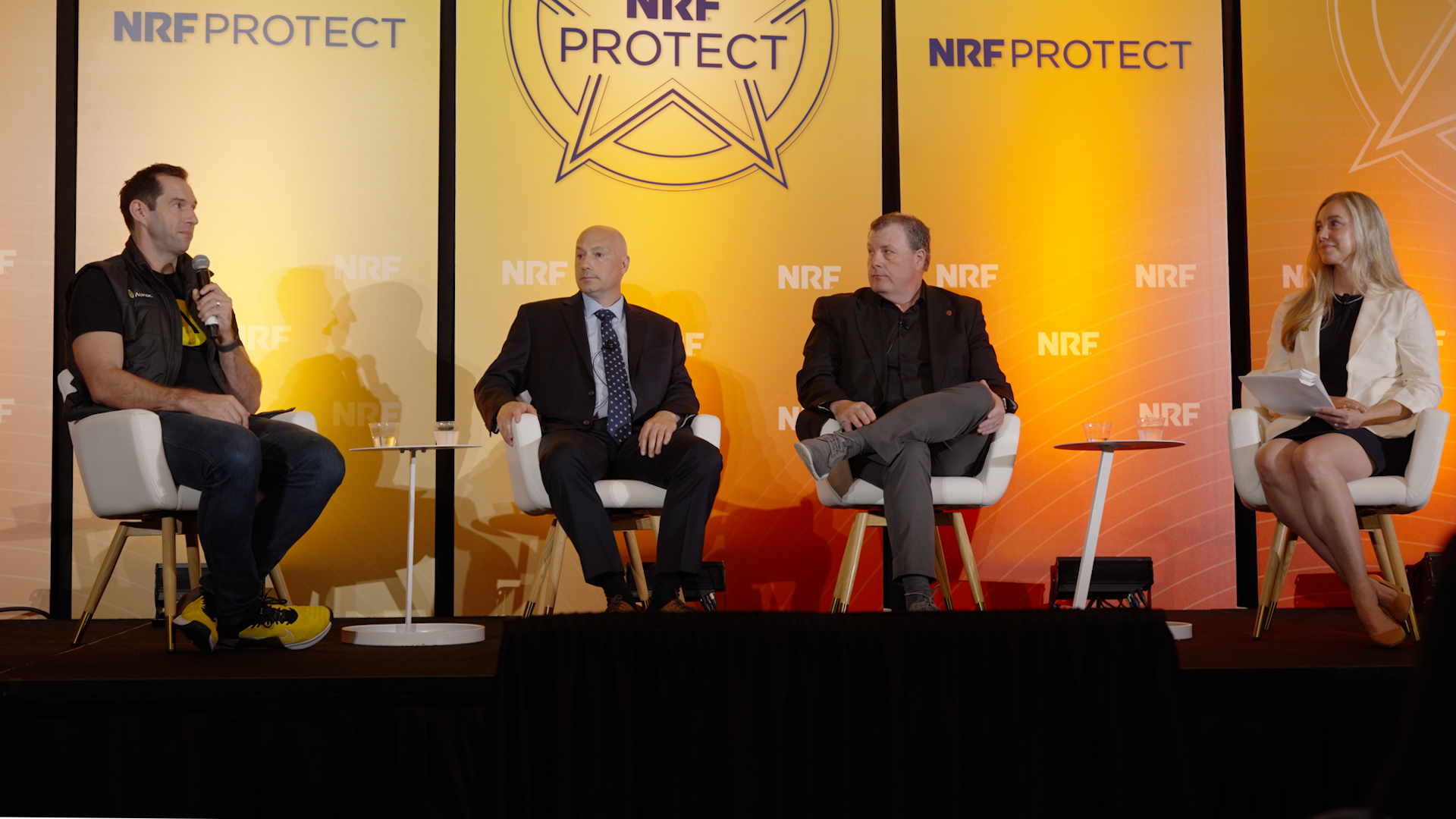 Auror co-founder and CEO Phil Thomson, Ulta Beauty Director of ORC Rory Stallard, and New York State Police senior investigator Mark Buglione and session moderator Rachel Hall of Axon presenting on stage at NRF Protect.