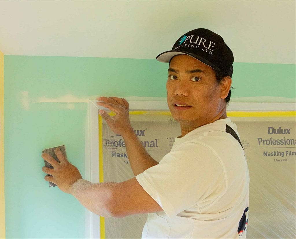 English Language Partners learner at work as a painter