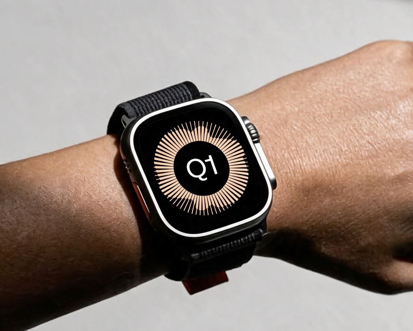 A smartwatch on a wrist with Q1 on its screen