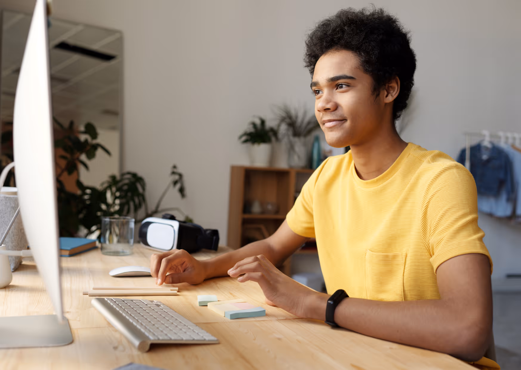 A teenage student working at a computer