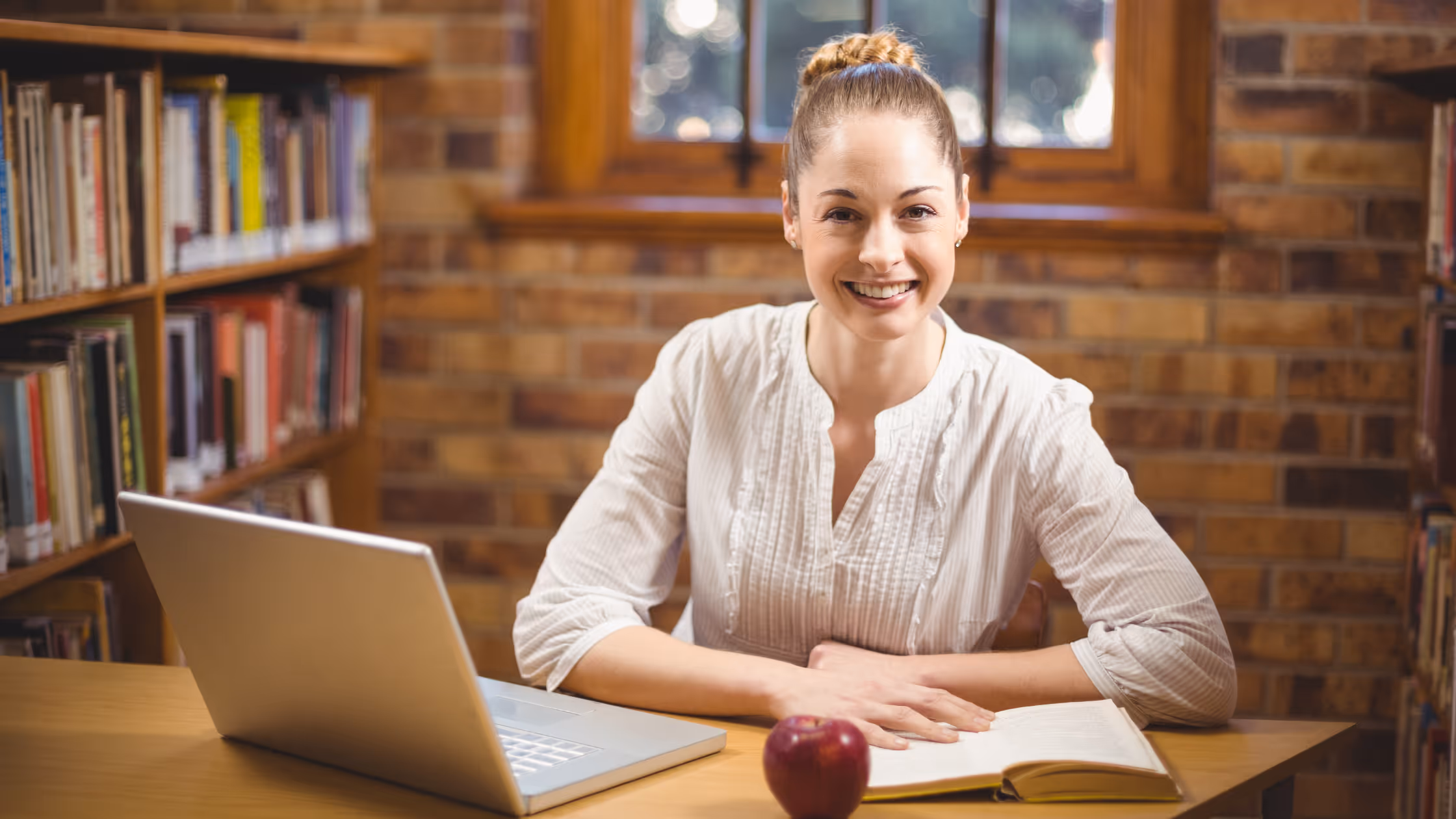 A SMHL teacher sitting at her laptop
