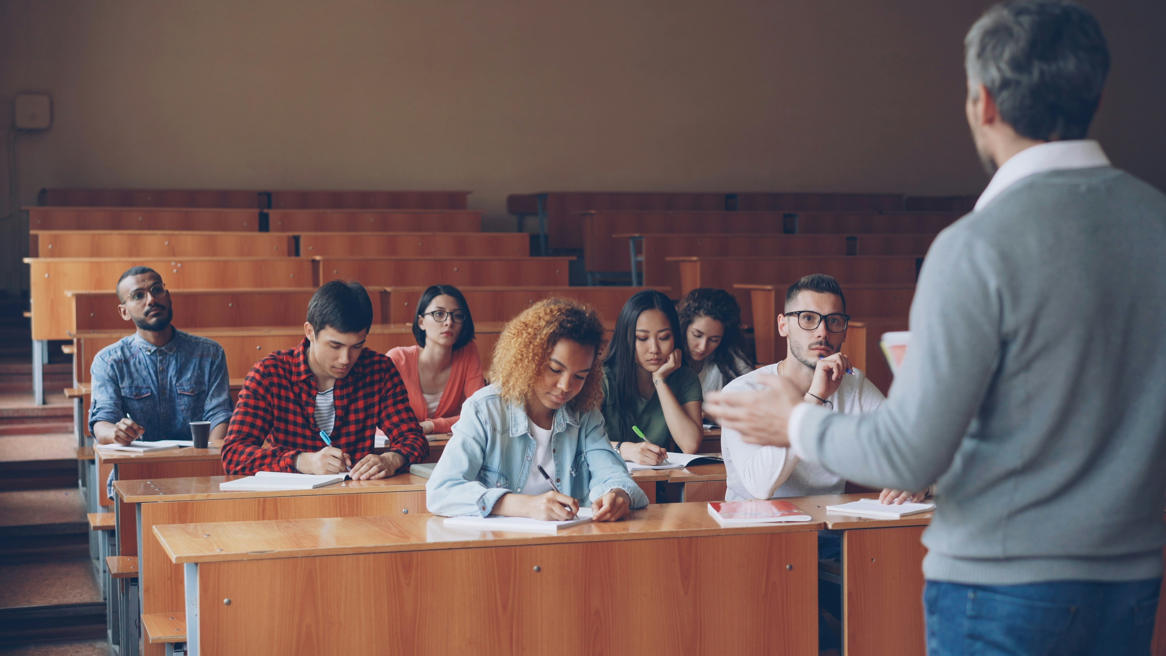A lecture hall with students and instructor at the front