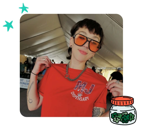 Erin Connorton is smiling while wearing a MJ Dispensary shirt proudly.