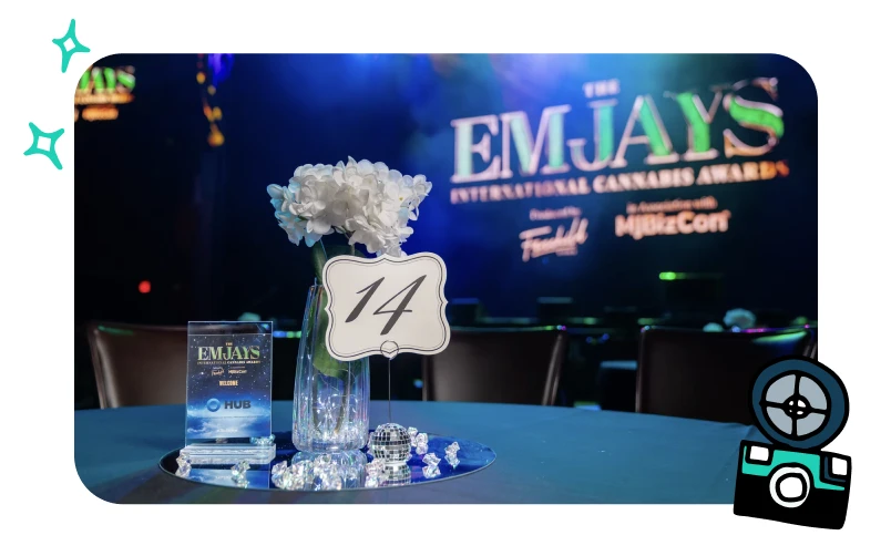 Emjays awards seating table at MJBizCon featuring formal place settings and cannabis industry event branding.
