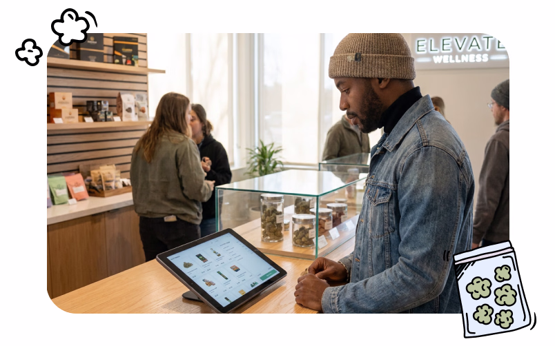 A man in a newly opened dispensary is browsing cannabis products on a tablet.