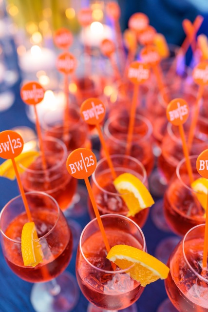 orange cocktails with 25th anniversary stirrers