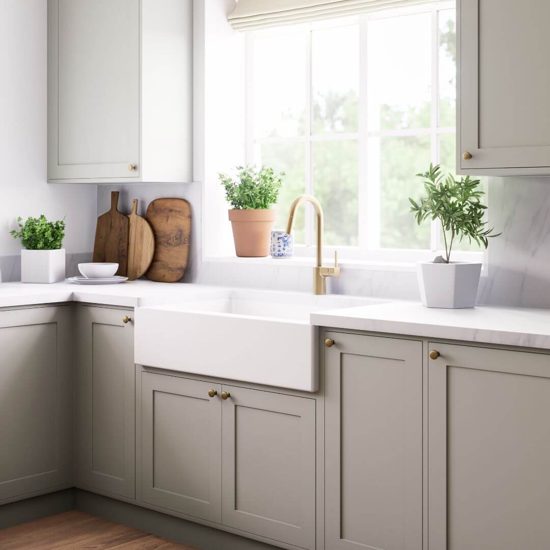 Image of a white kitchen sink with cream cupboards 