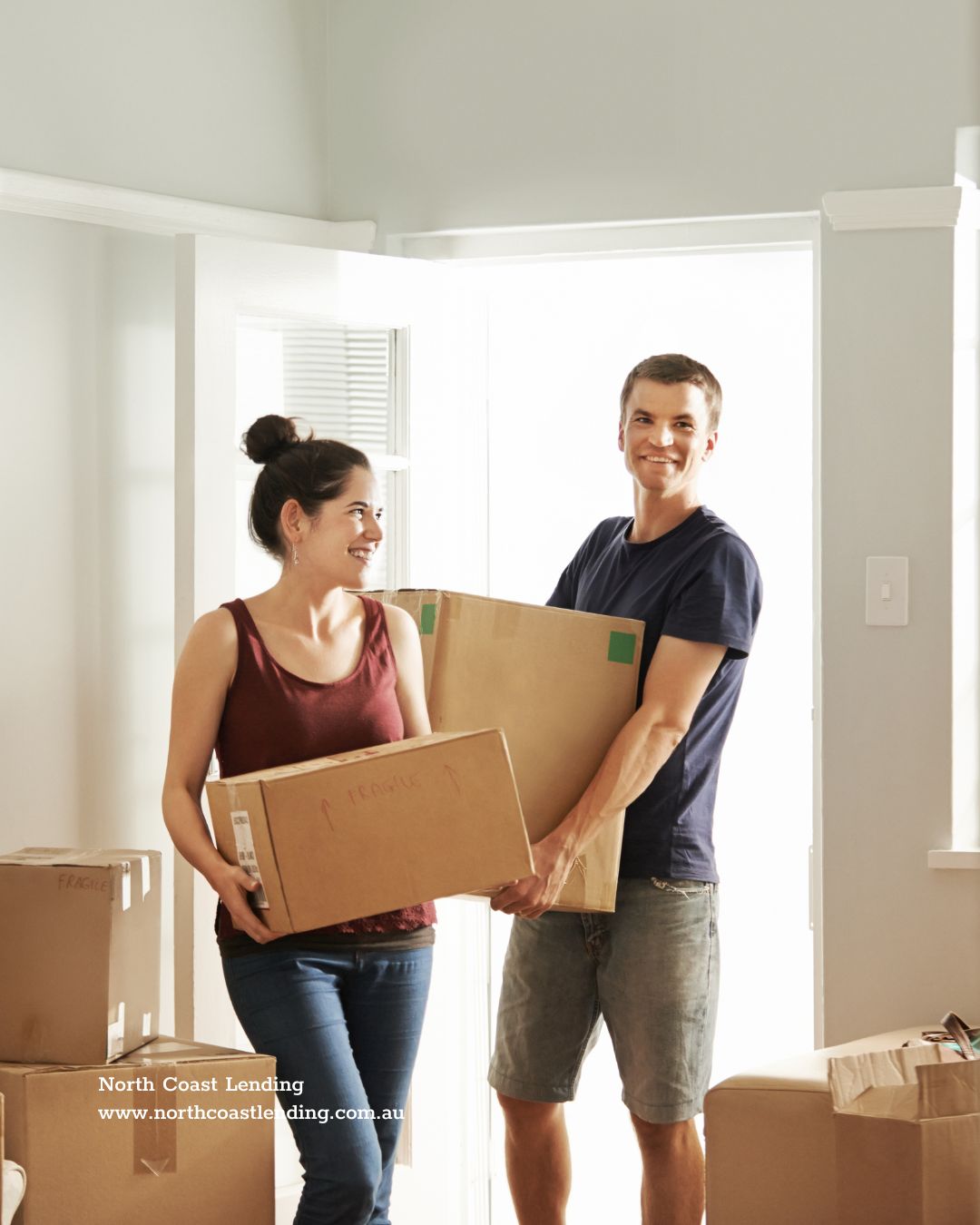 A young couple (first home buyers) with boxes moving into a house 
