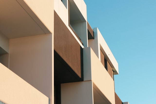 View of a section of an apartment block looking up towards the sky