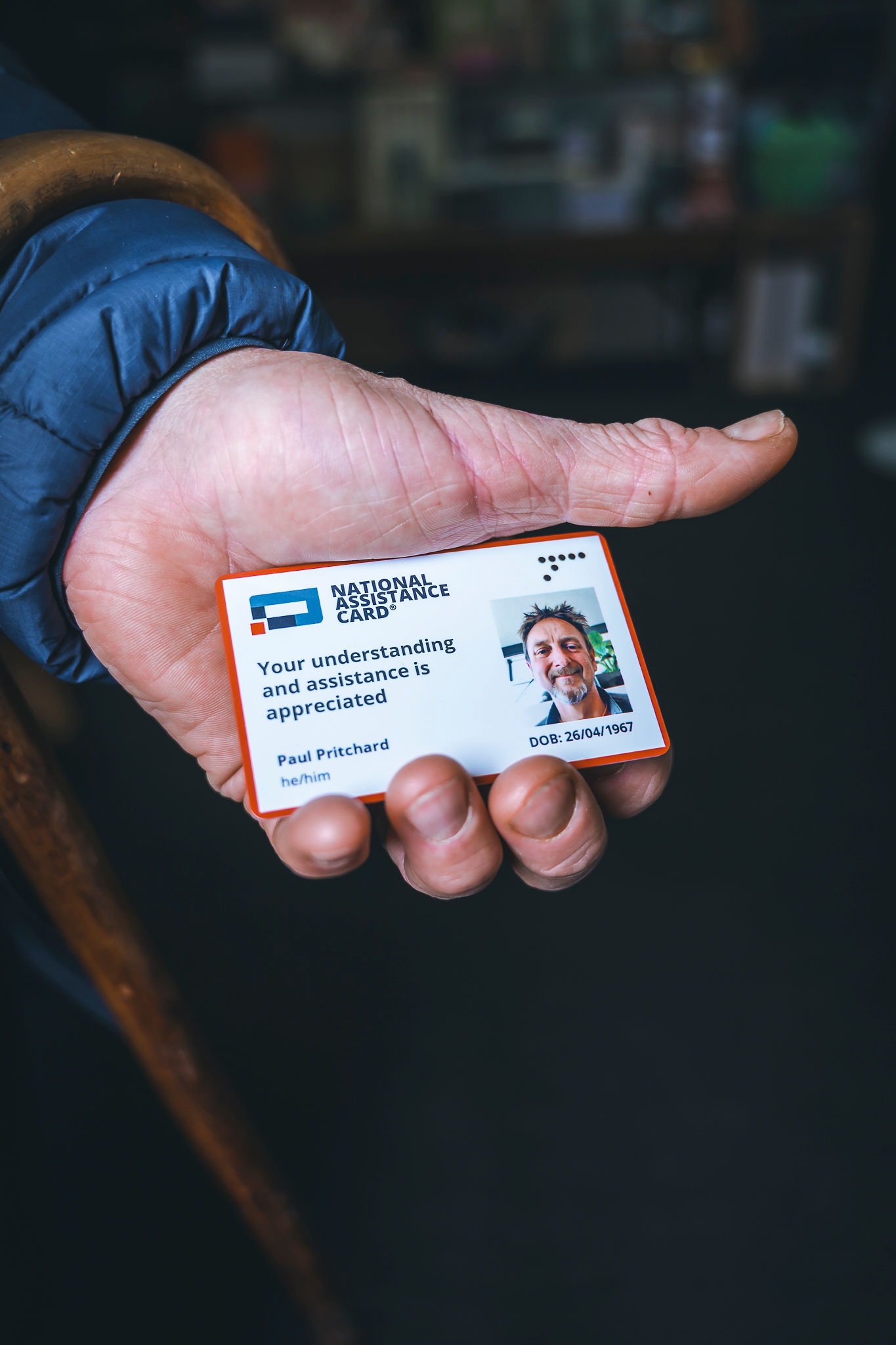 An image of hand holding National Assistance Card