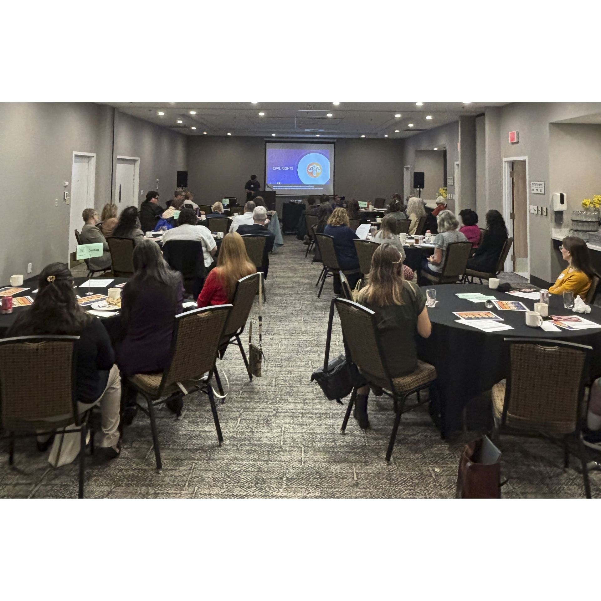 Participants at the third annual CAC Legislative Breakfast at tables in conference room