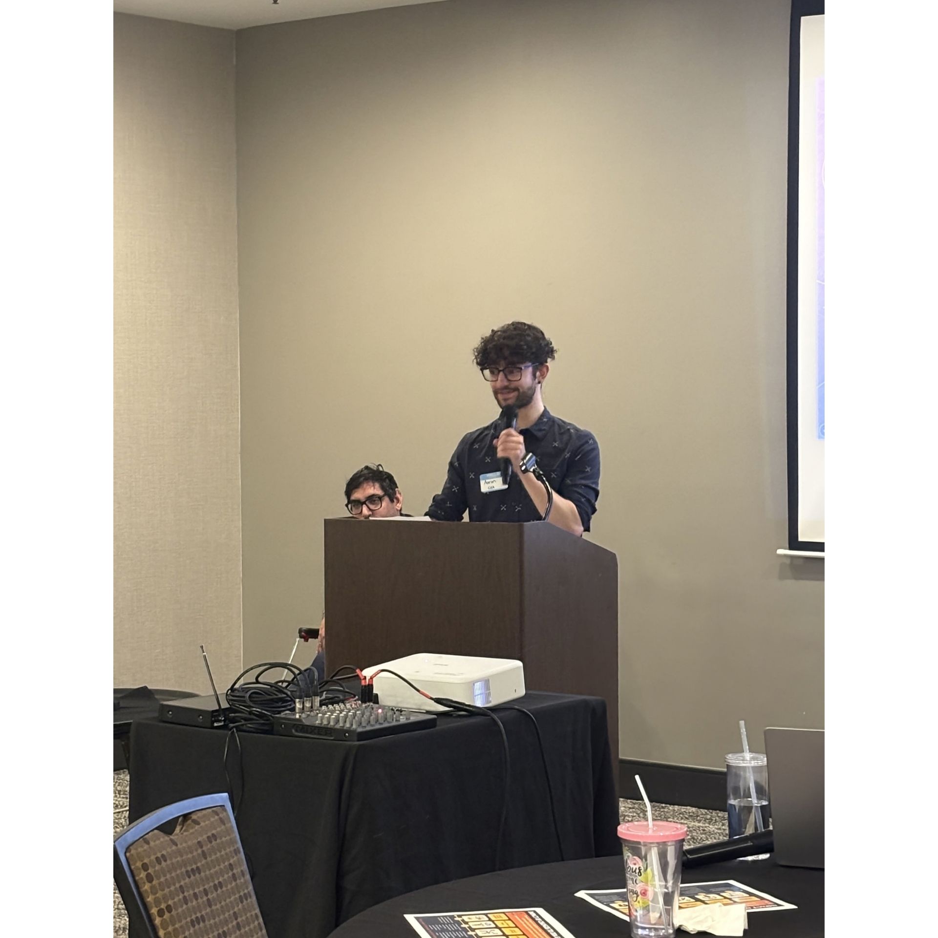 Aaron Dickson speaks at podium