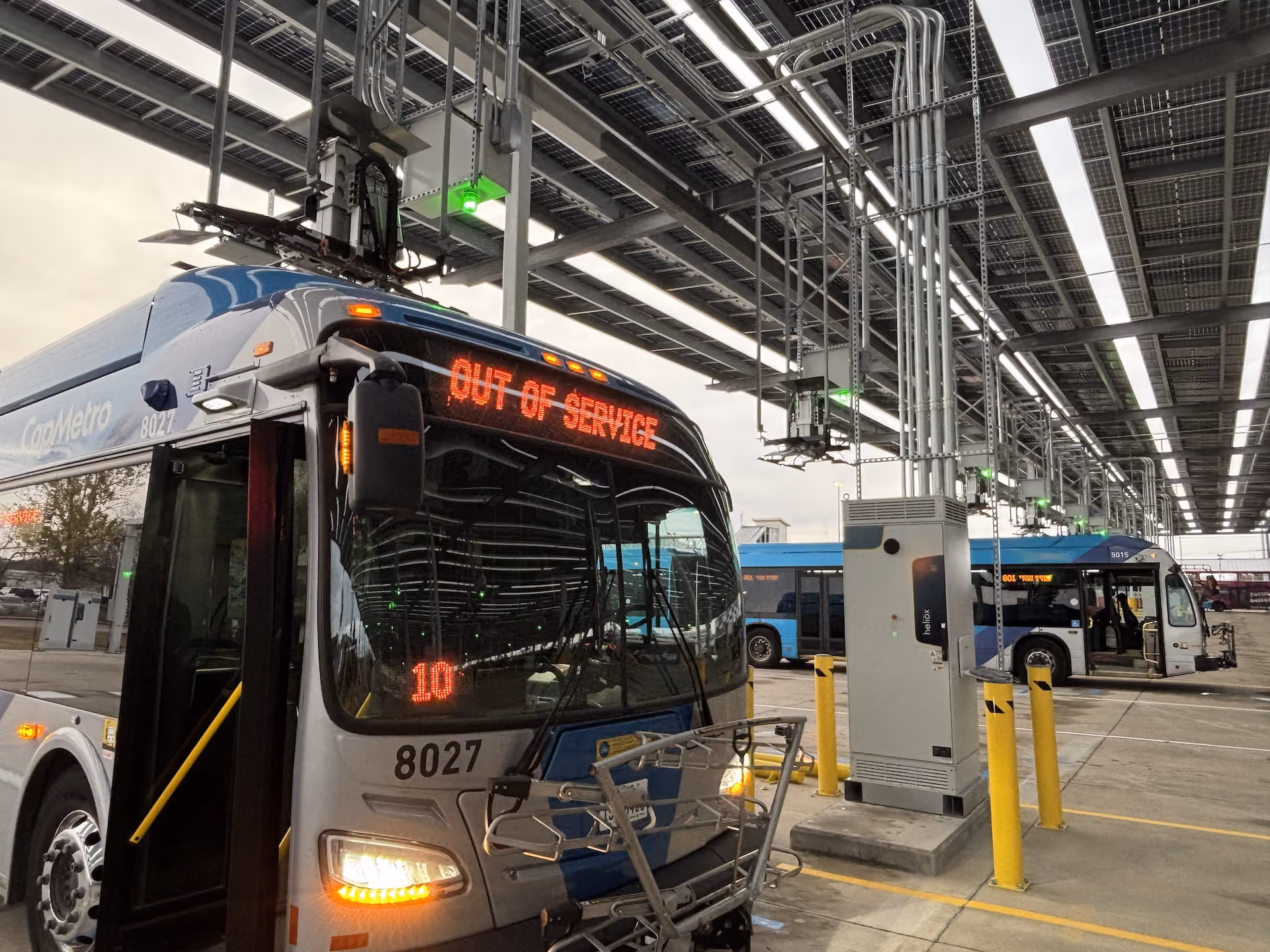 Heliox charger at an electric bus depot with transit buses charging under overhead pantographs